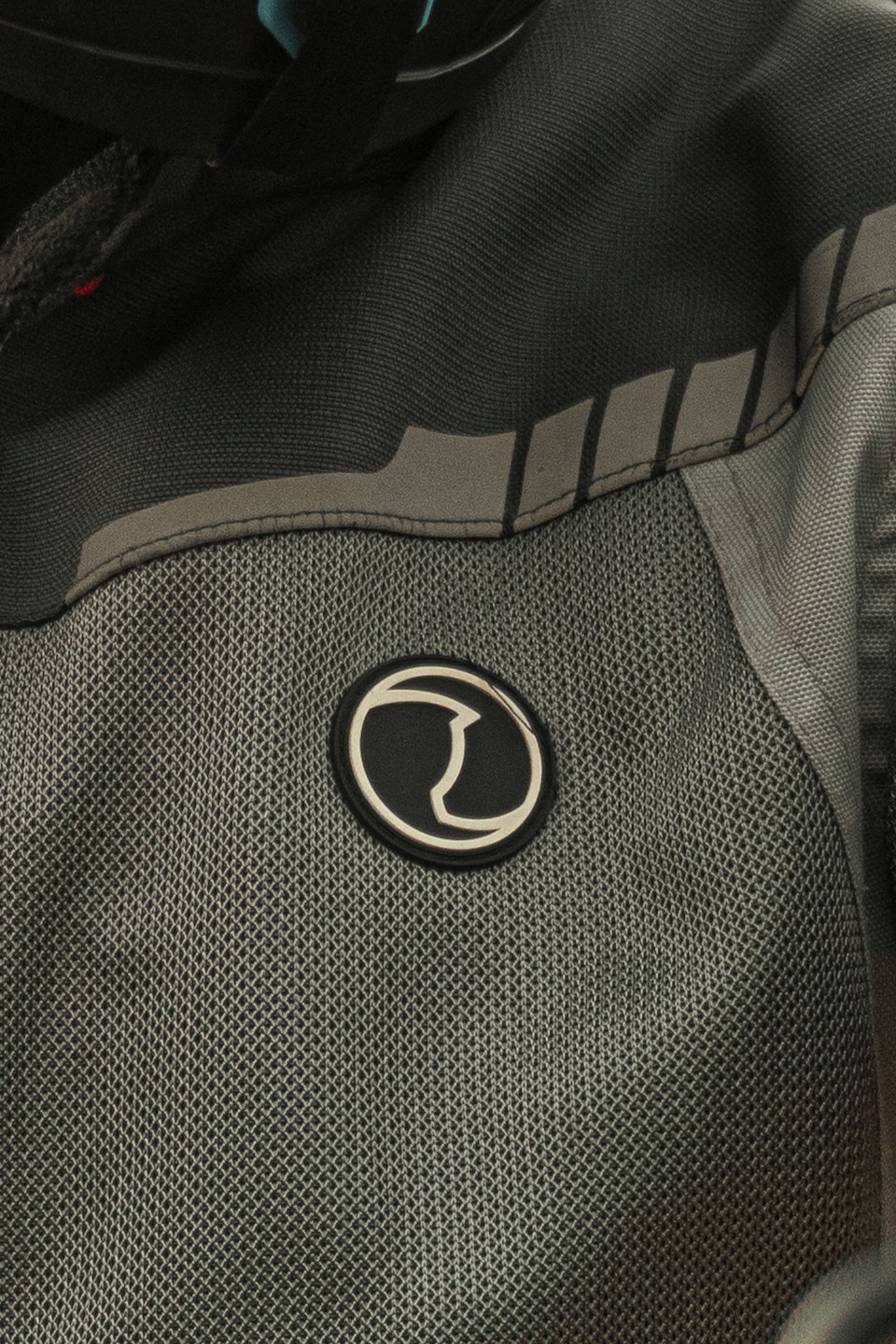 Close up of textured athletic fabric with an embossed logo.
